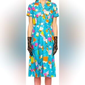 Gucci short sleeve mid-length dress in blue with multicolored floral pattern.